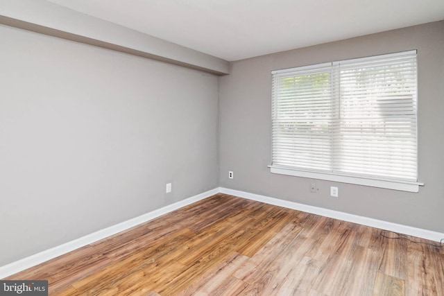 unfurnished room with hardwood / wood-style floors