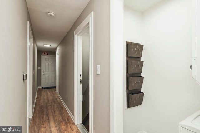 hall featuring dark wood finished floors and baseboards