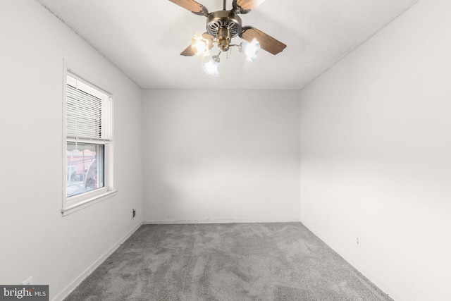 empty room with ceiling fan and light carpet