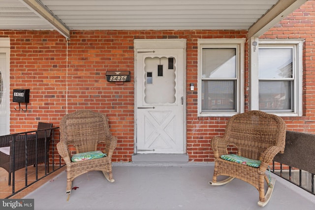 entrance to property with brick siding