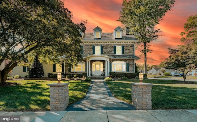 view of front of house with a yard