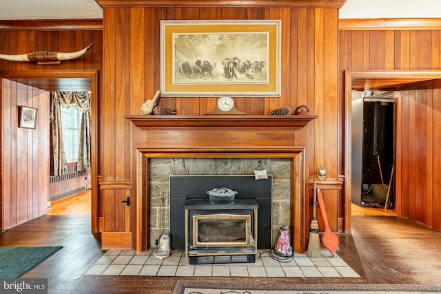 interior details featuring wood-type flooring and wooden walls