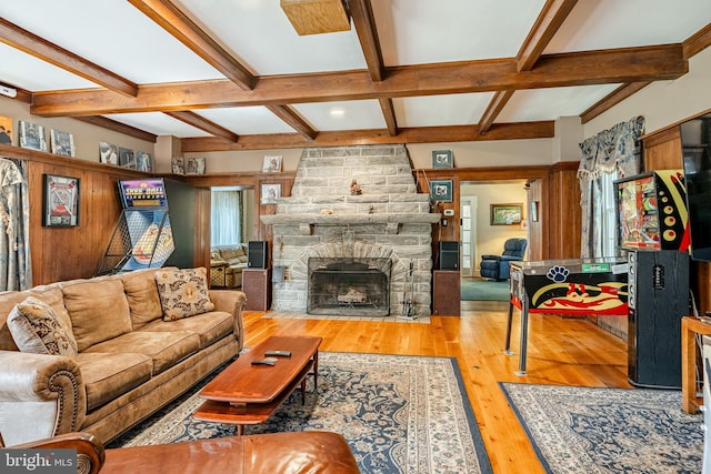 living room with coffered ceiling, a fireplace, beam ceiling, and light hardwood / wood-style flooring