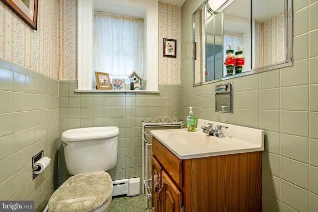 bathroom with vanity, toilet, tile walls, and a baseboard radiator