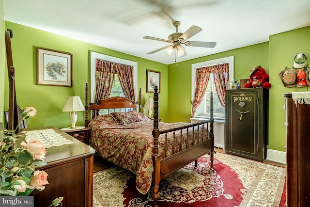 bedroom featuring ceiling fan and multiple windows