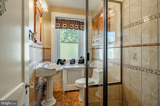 bathroom with tile walls and toilet