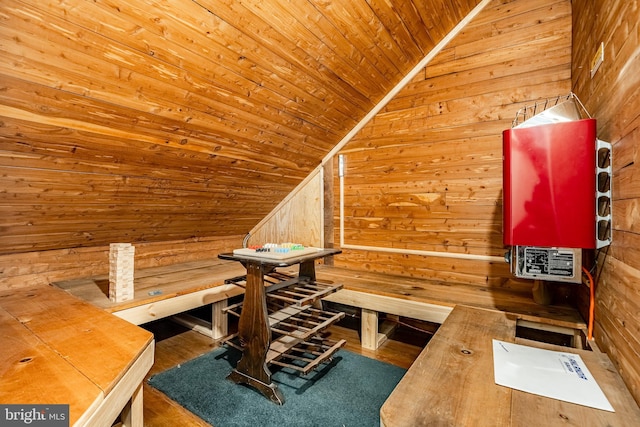 interior space with wood ceiling, wood-type flooring, and wood walls