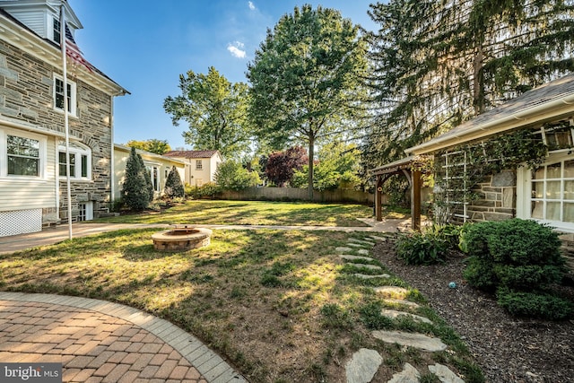 view of yard with a fire pit and a patio