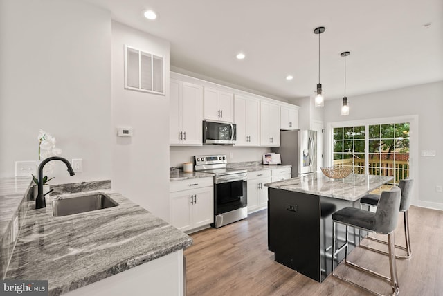 kitchen featuring white cabinetry, sink, light hardwood / wood-style flooring, and stainless steel appliances