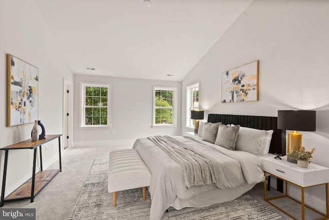 bedroom featuring light carpet and vaulted ceiling