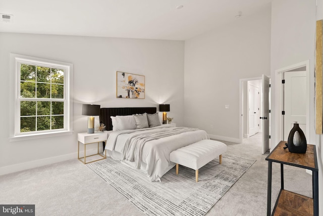 bedroom featuring lofted ceiling and carpet