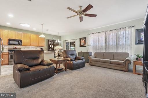 living room with light carpet and ceiling fan