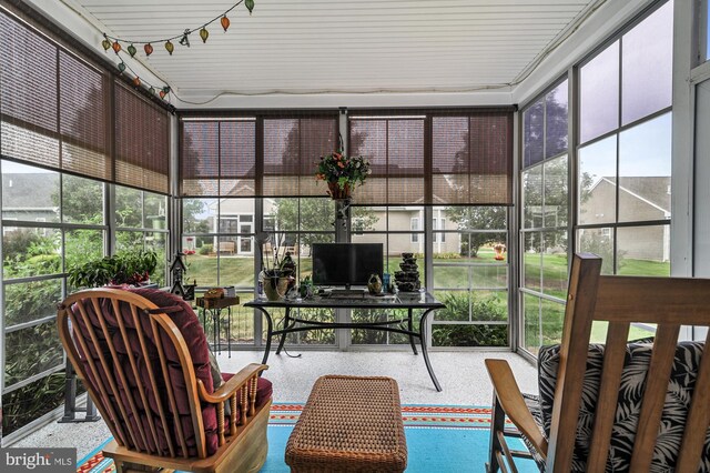 carpeted home office featuring lofted ceiling