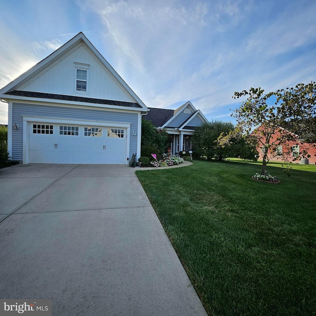 view of front of home with a garage and a front lawn