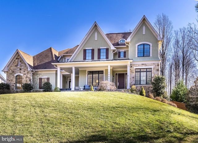 craftsman-style home with covered porch and a front yard