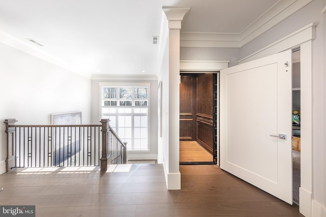 hallway with hardwood / wood-style floors and crown molding