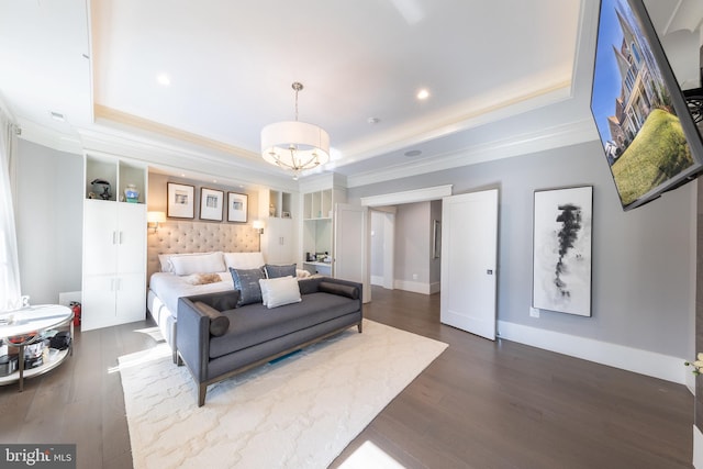 bedroom featuring dark hardwood / wood-style flooring, a raised ceiling, and an inviting chandelier