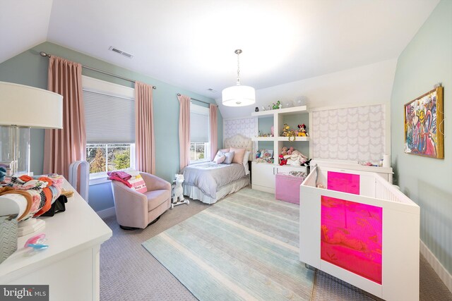 bedroom with carpet floors and lofted ceiling