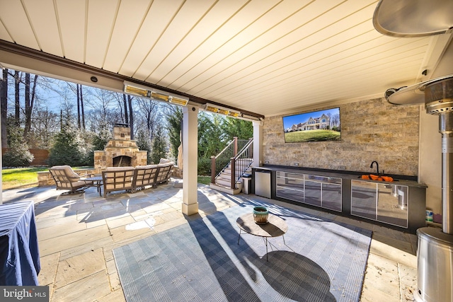 view of patio / terrace with an outdoor living space with a fireplace