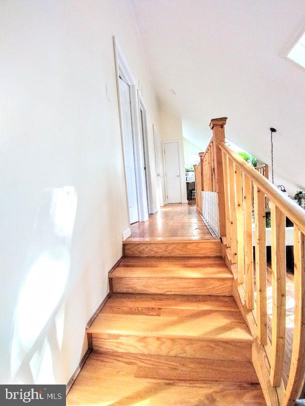 stairway featuring hardwood / wood-style flooring