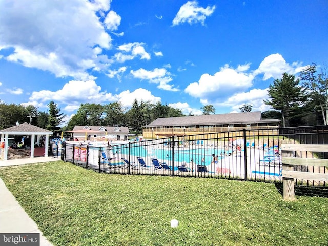 view of swimming pool with a yard and a gazebo