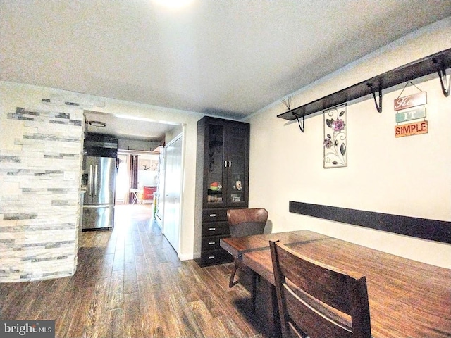 hallway with hardwood / wood-style floors and a textured ceiling