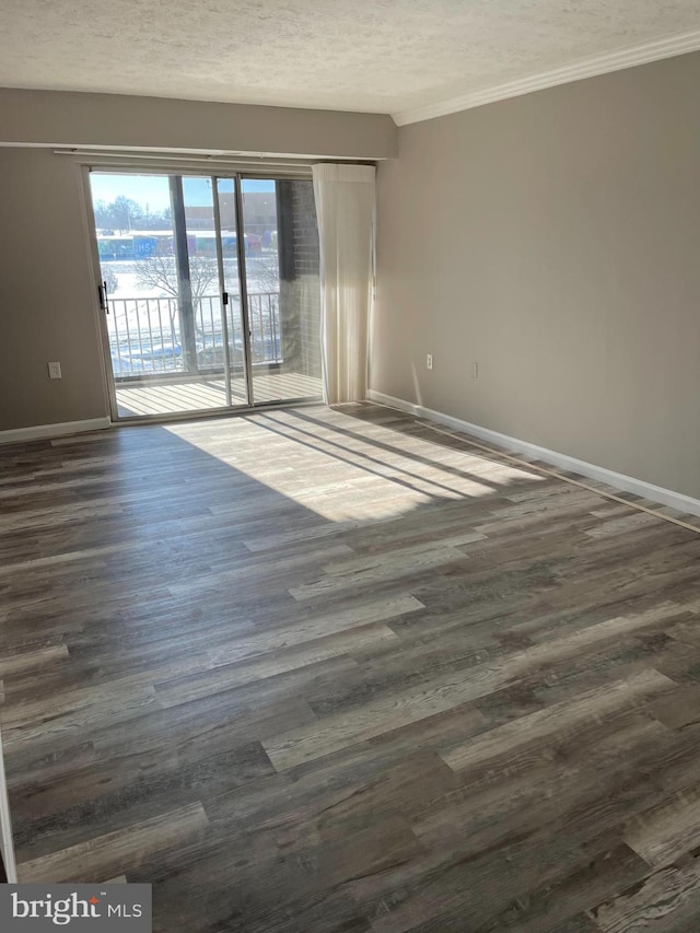 unfurnished room with ornamental molding, dark hardwood / wood-style floors, and a textured ceiling