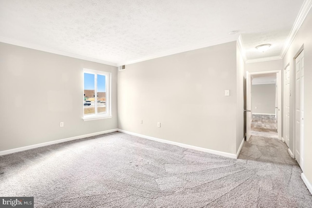 empty room featuring ornamental molding, light carpet, and a textured ceiling