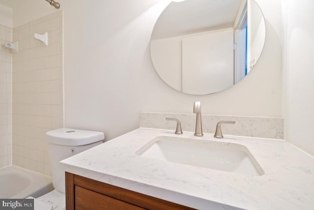 full bathroom featuring vanity, toilet, and tiled shower / bath