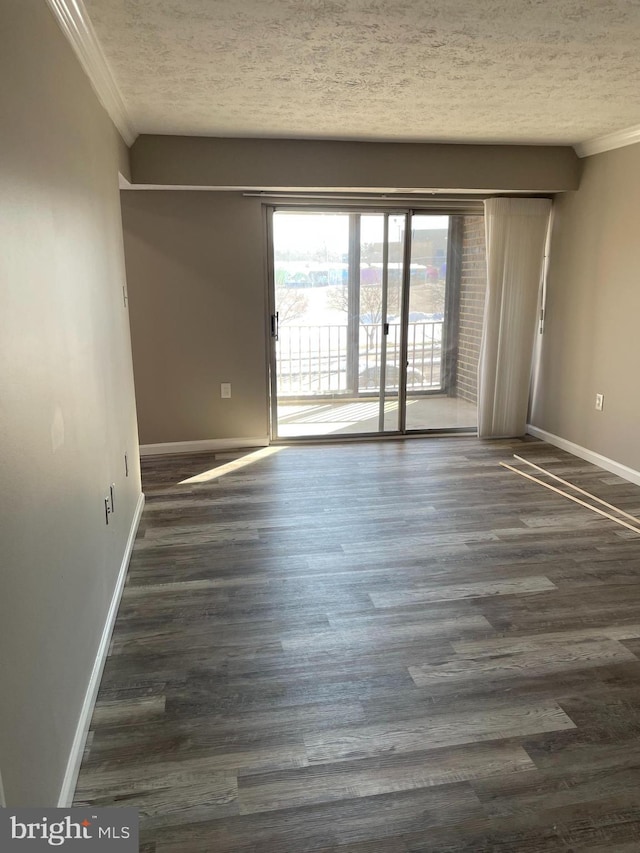 unfurnished room with crown molding, dark hardwood / wood-style floors, and a textured ceiling