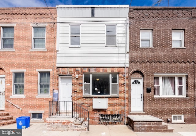 view of property with brick siding