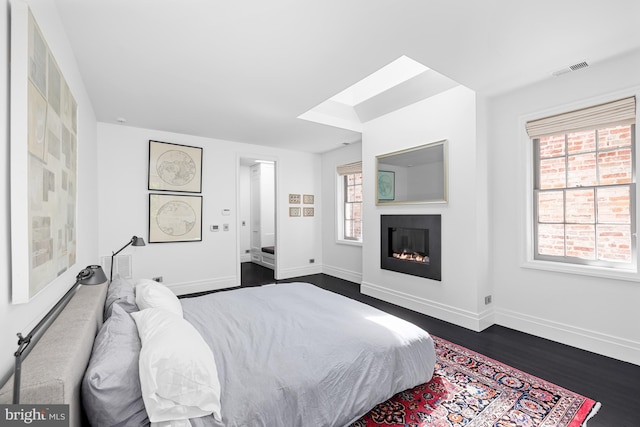bedroom featuring multiple windows, visible vents, and baseboards