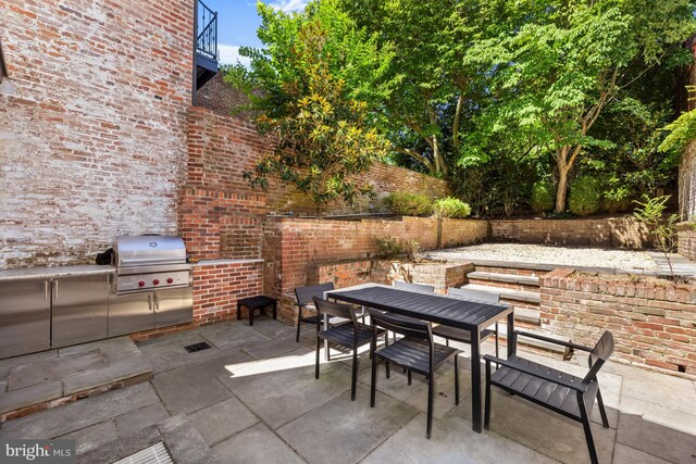 view of patio featuring area for grilling and a grill