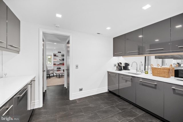 kitchen featuring gray cabinetry and sink