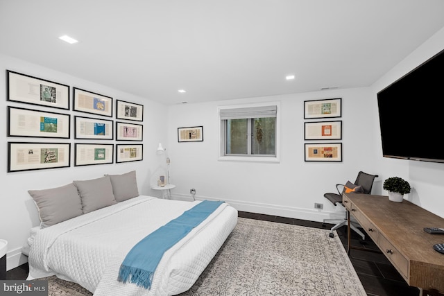 bedroom with dark hardwood / wood-style floors