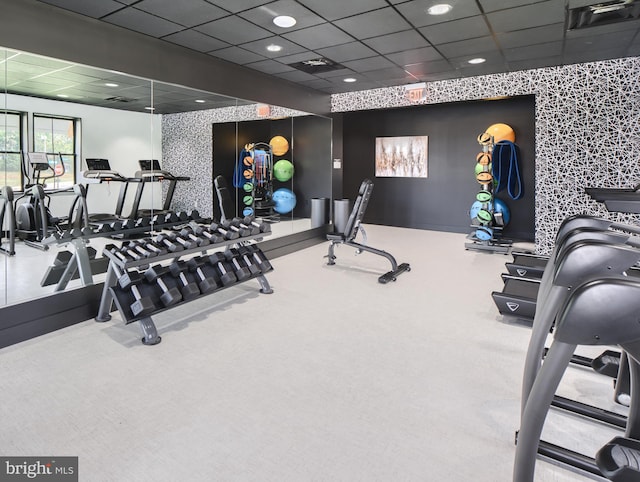 gym with carpet flooring and a paneled ceiling