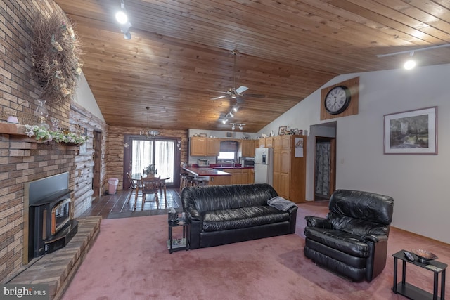 living room featuring a wood stove, ceiling fan, and wooden ceiling