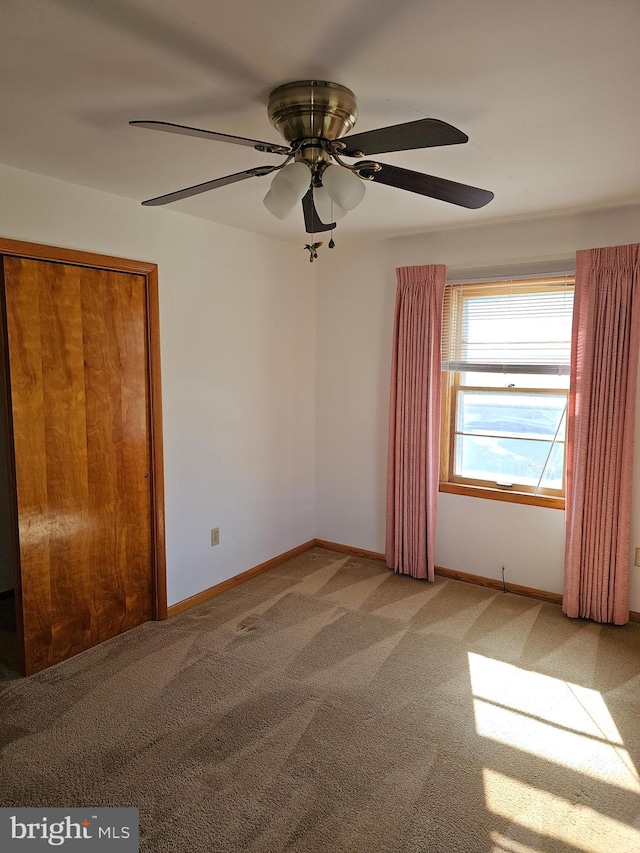 unfurnished bedroom featuring a closet, carpet floors, and ceiling fan