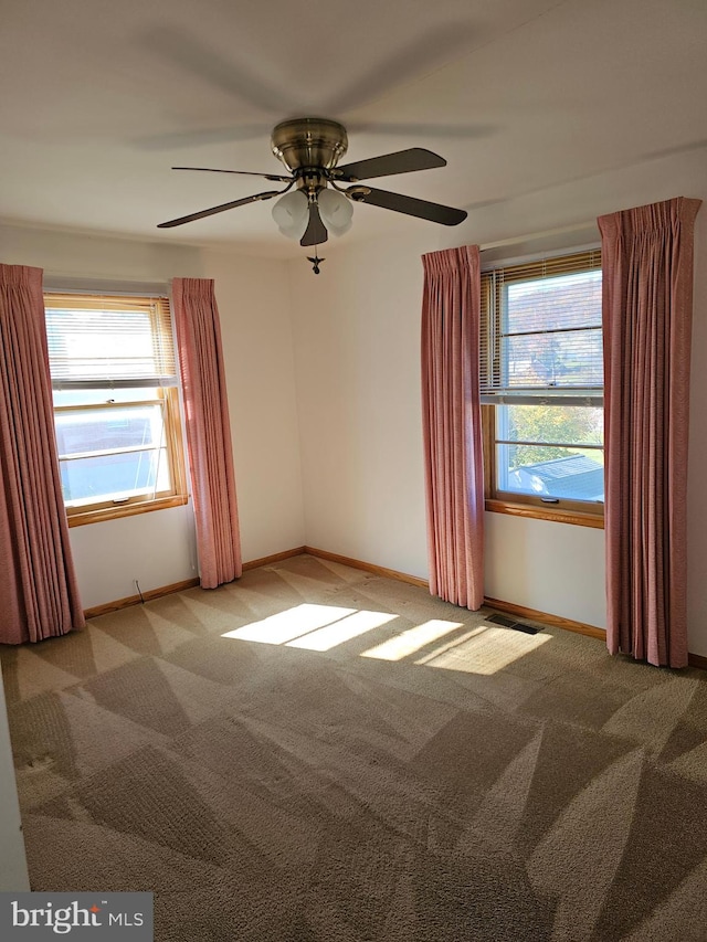 carpeted empty room featuring ceiling fan