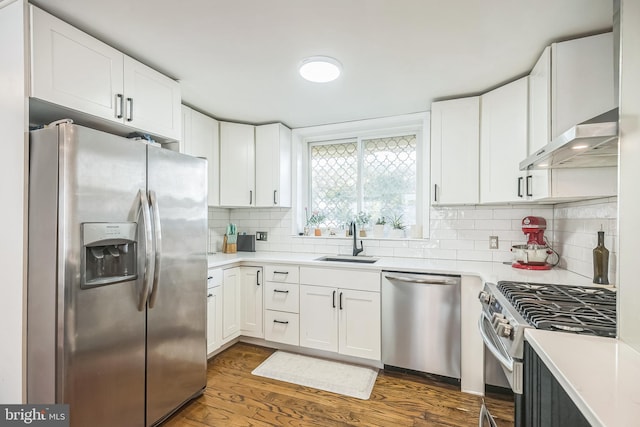 kitchen with sink, white cabinetry, ventilation hood, stainless steel appliances, and dark hardwood / wood-style floors