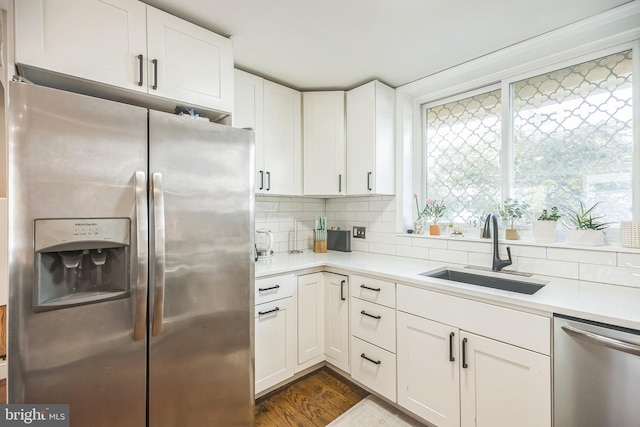 kitchen featuring sink, dark hardwood / wood-style flooring, stainless steel appliances, and white cabinets