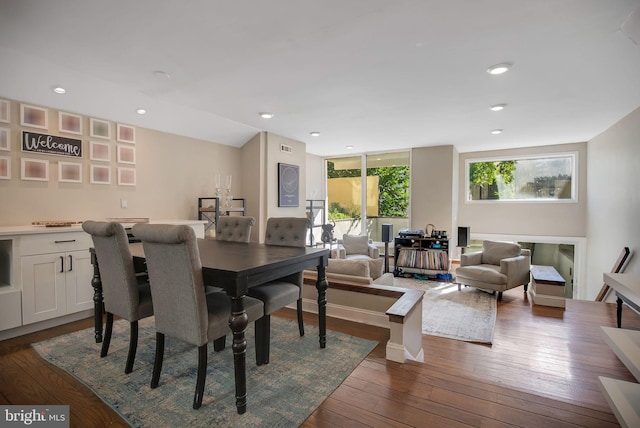 dining area featuring dark hardwood / wood-style floors and a fireplace