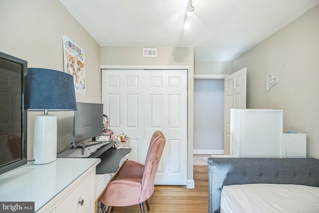 bedroom featuring light hardwood / wood-style floors and a closet