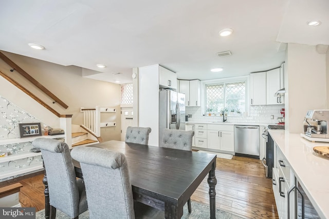 dining room featuring wood-type flooring and sink