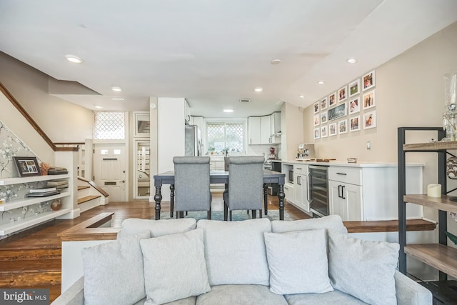 living room featuring dark hardwood / wood-style floors and beverage cooler