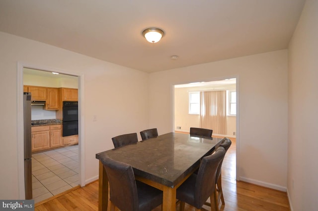 dining area featuring light wood-type flooring