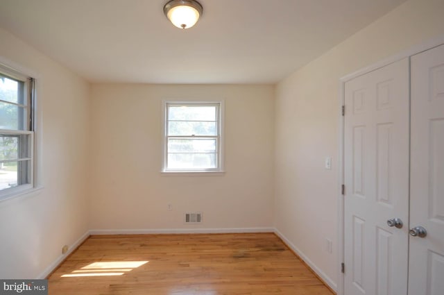 unfurnished room with light wood-type flooring