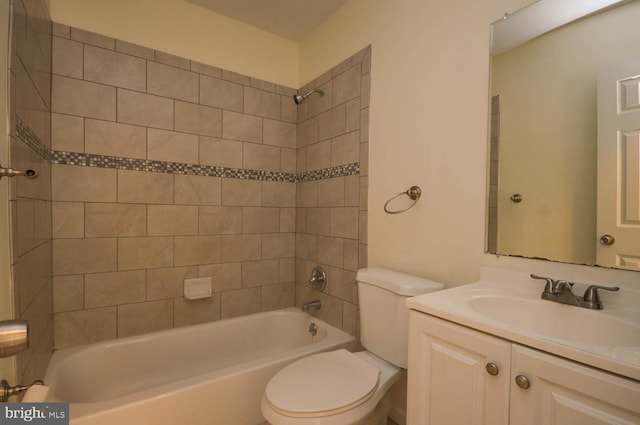 full bathroom featuring tiled shower / bath combo, vanity, and toilet