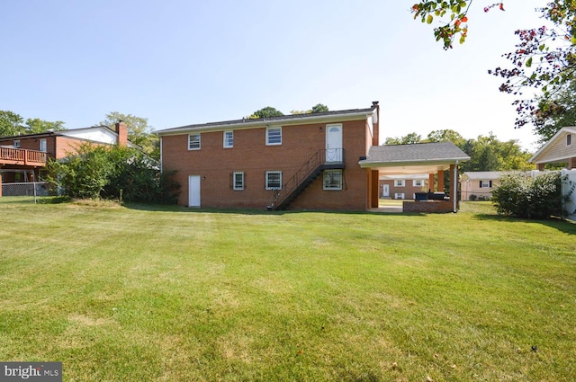 back of property featuring a lawn