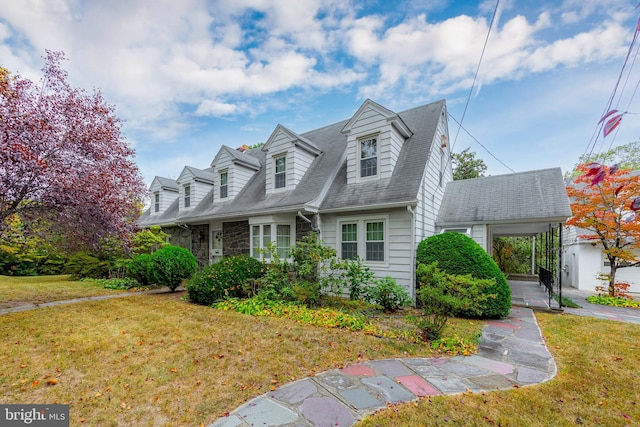 cape cod-style house with covered porch and a front yard